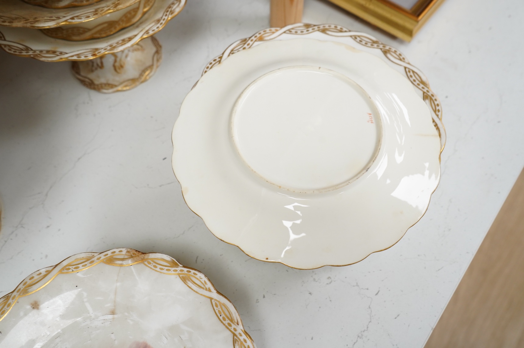 A Late 19th century Minton porcelain part dessert service, each piece painted with differing landscapes, largest 28cm in diameter
